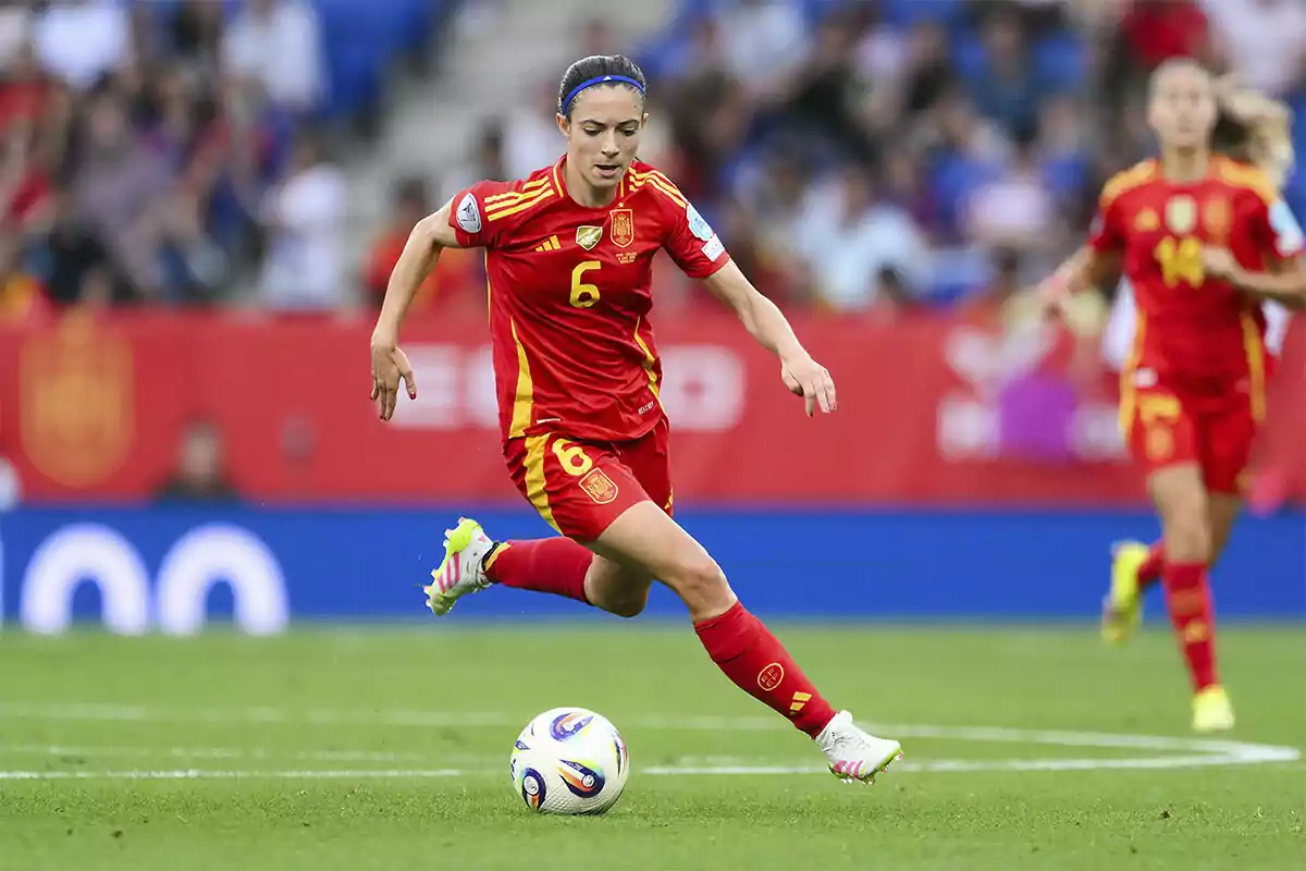 Futbolista de la selección femenina de España corriendo con el balón durante un partido Futbolista de la selección femenina de España corriendo con el balón durante un partido