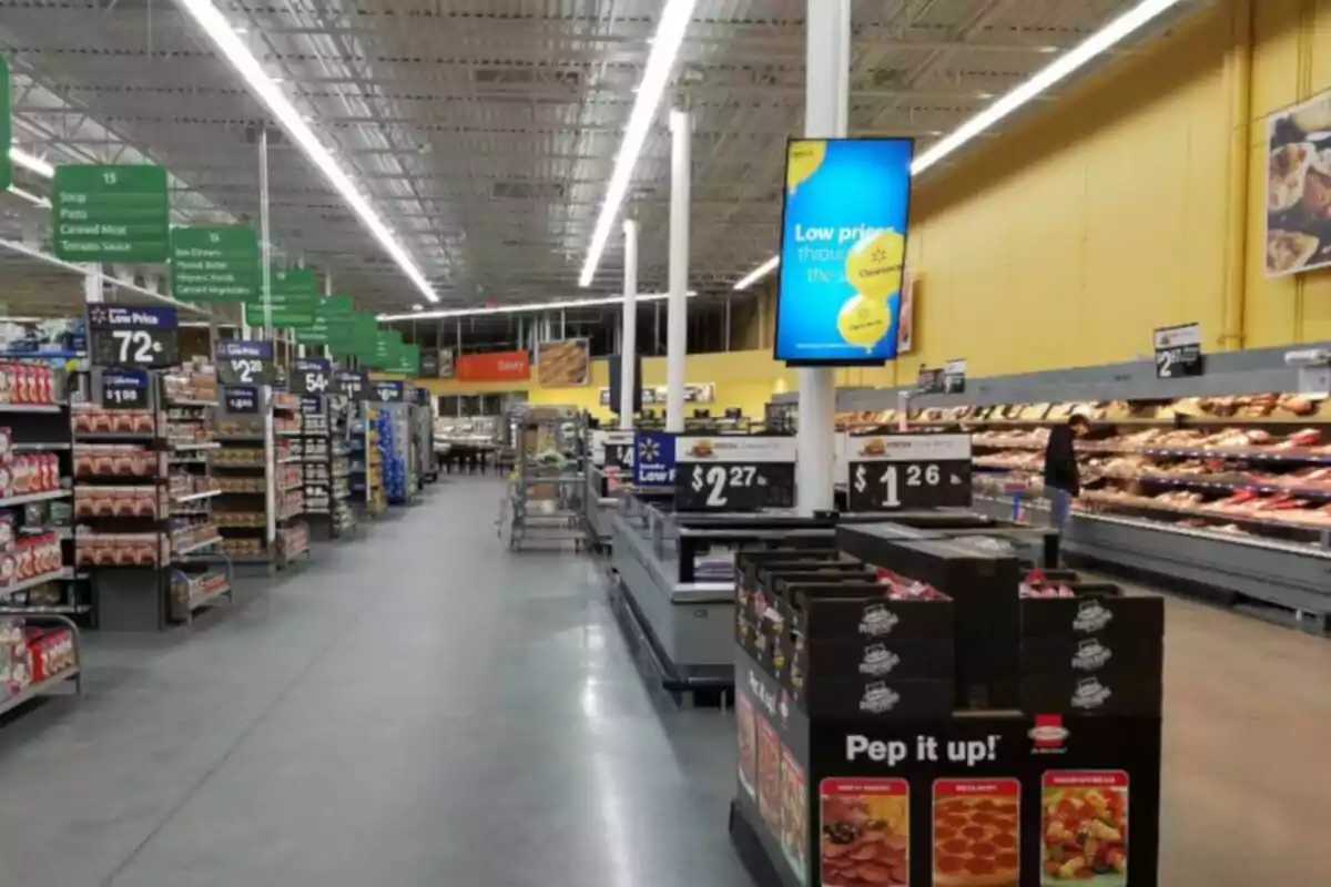 Supermarket aisle with shelves full of products and low price signage