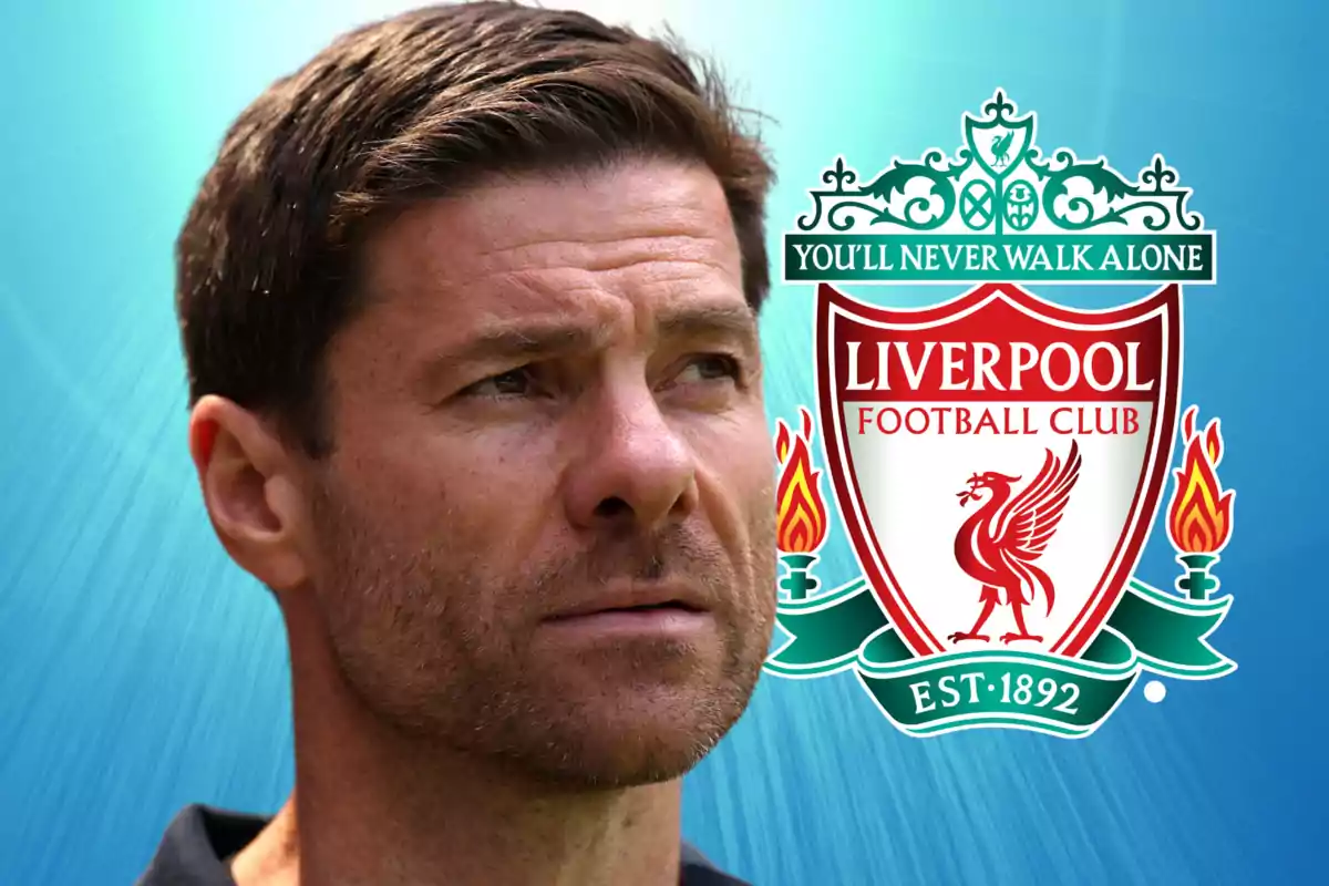 Short-haired man looking forward with the Liverpool Football Club crest in the background on a blue backdrop