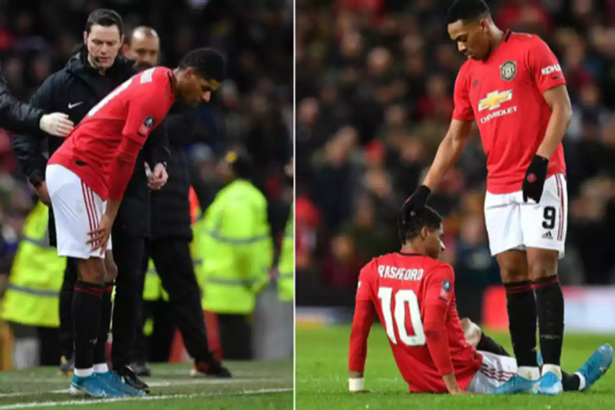 Two Manchester United footballers on the field, one of them is injured and receives support from his teammate during a match. Two Manchester United footballers on the field, one of them is injured and receives support from his teammate during a match.