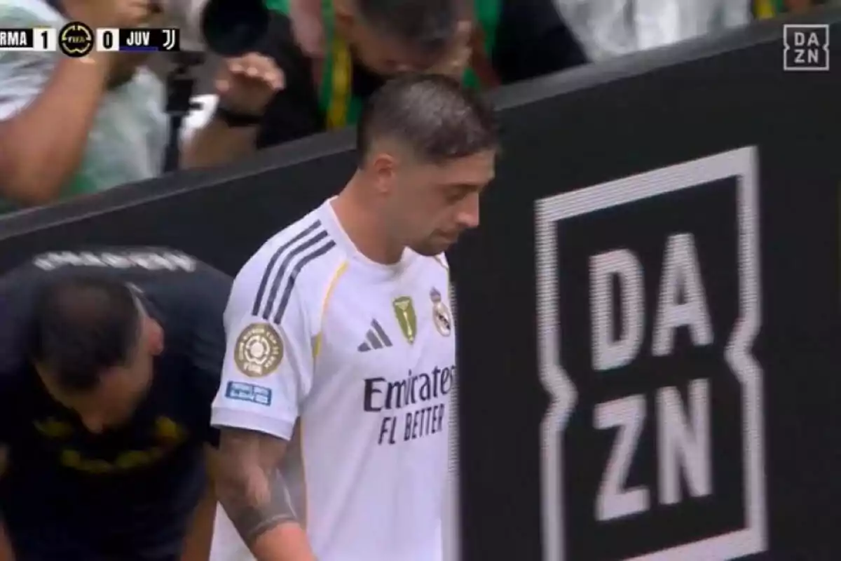 Real Madrid player with a serious expression walking near the sideline during a match broadcast by DAZN Real Madrid player with a serious expression walking near the sideline during a match broadcast by DAZN