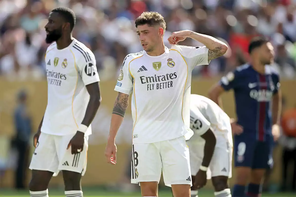 Real Madrid players on the field during a soccer match with the opposing team in the background Real Madrid players on the field during a soccer match with the opposing team in the background