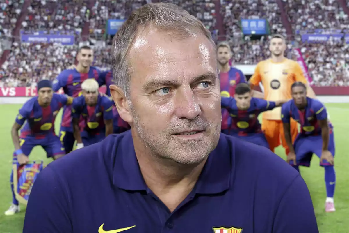 Un entrenador de fútbol con camiseta del Barcelona aparece en primer plano mientras el equipo posa para una foto grupal en el estadio lleno de aficionados.