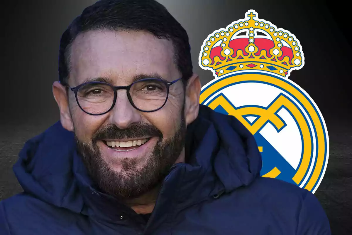 Man with glasses and a beard smiling in front of the Real Madrid crest