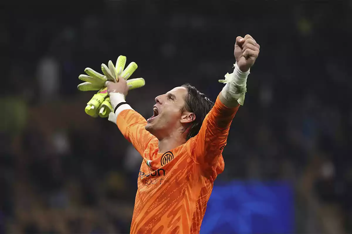 Soccer goalkeeper celebrating with arms raised and gloves in hand during a match Soccer goalkeeper celebrating with arms raised and gloves in hand during a match