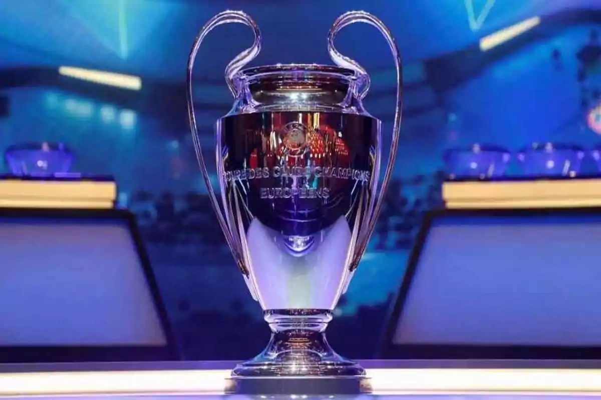 Champions League trophy on a table with a lit blue background