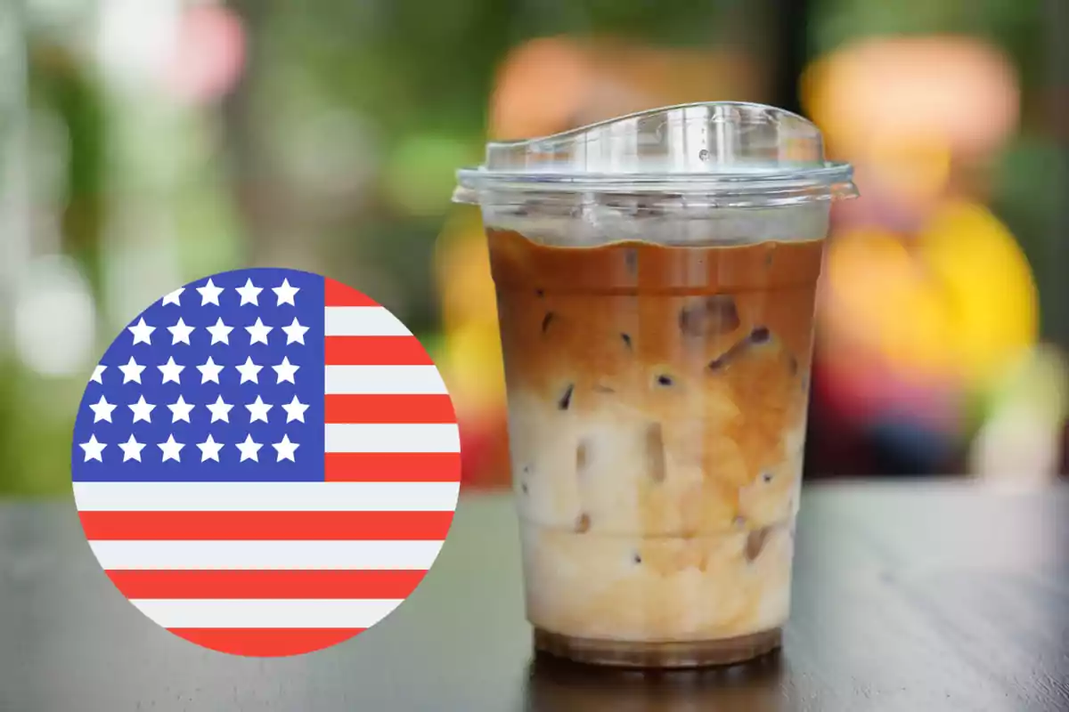 Iced coffee cup with milk next to a circle with the United States flag on a table