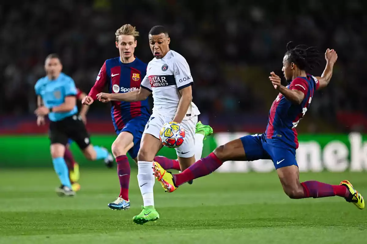A PSG player controls the ball while two Barcelona players try to stop him during a soccer match. A PSG player controls the ball while two Barcelona players try to stop him during a soccer match.