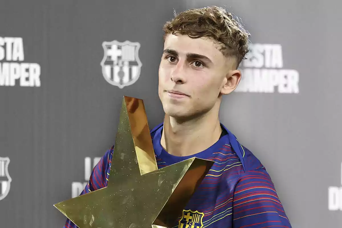 Young player wearing a Barcelona jersey holding a gold star-shaped trophy