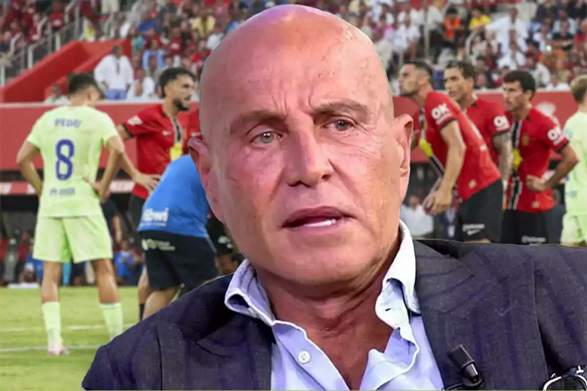 Un hombre calvo con expresión seria en primer plano con un partido de fútbol de fondo donde jugadores de dos equipos diferentes están en el campo