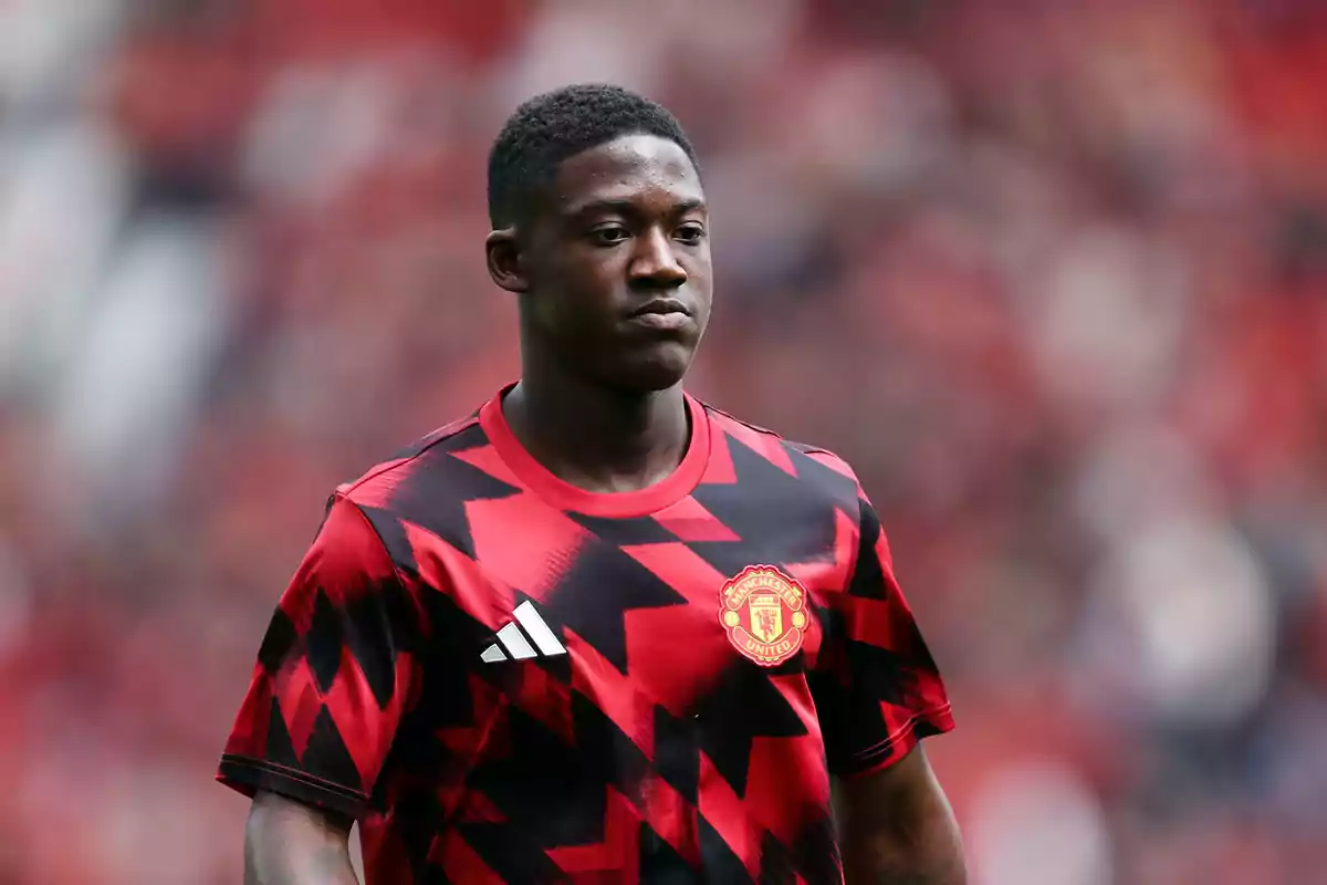 Soccer player wearing a Manchester United training jersey in a stadium Soccer player wearing a Manchester United training jersey in a stadium