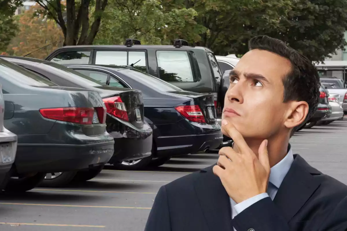 Thoughtful man in a parking lot full of cars