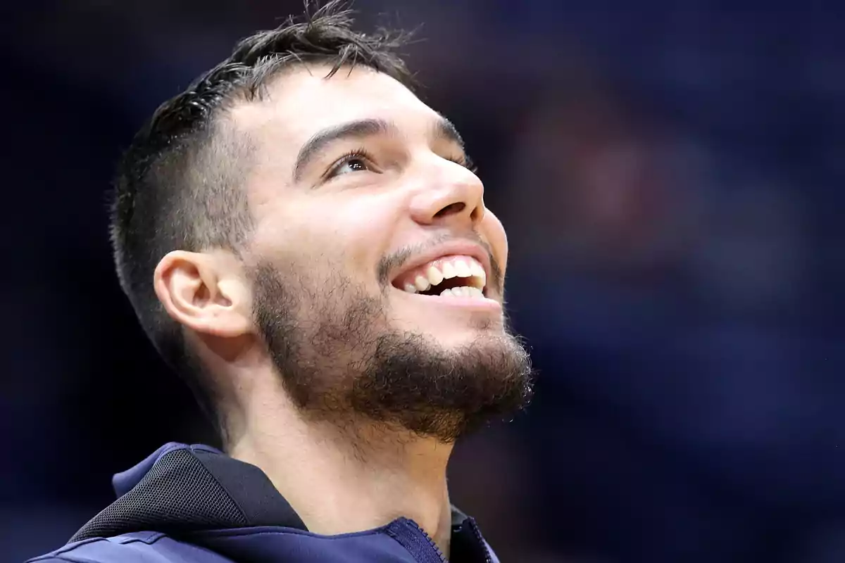 Young man with a beard and short hair smiling and looking up with a blurred background. Young man with a beard and short hair smiling and looking up with a blurred background.