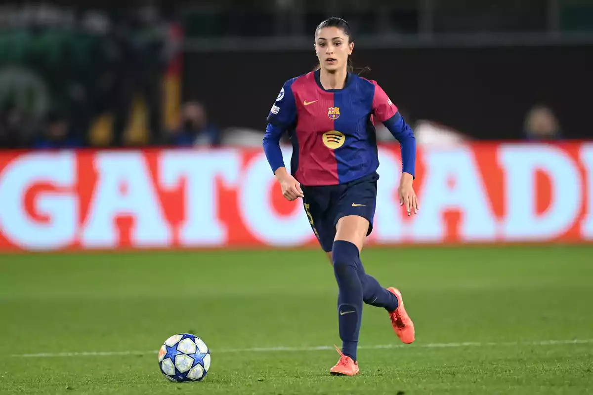 FC Barcelona women's player running on the field during a match with the ball nearby FC Barcelona women's player running on the field during a match with the ball nearby