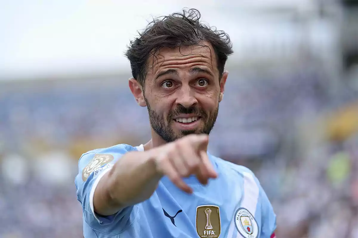Soccer player in a light blue uniform pointing forward during a match Soccer player in a light blue uniform pointing forward during a match