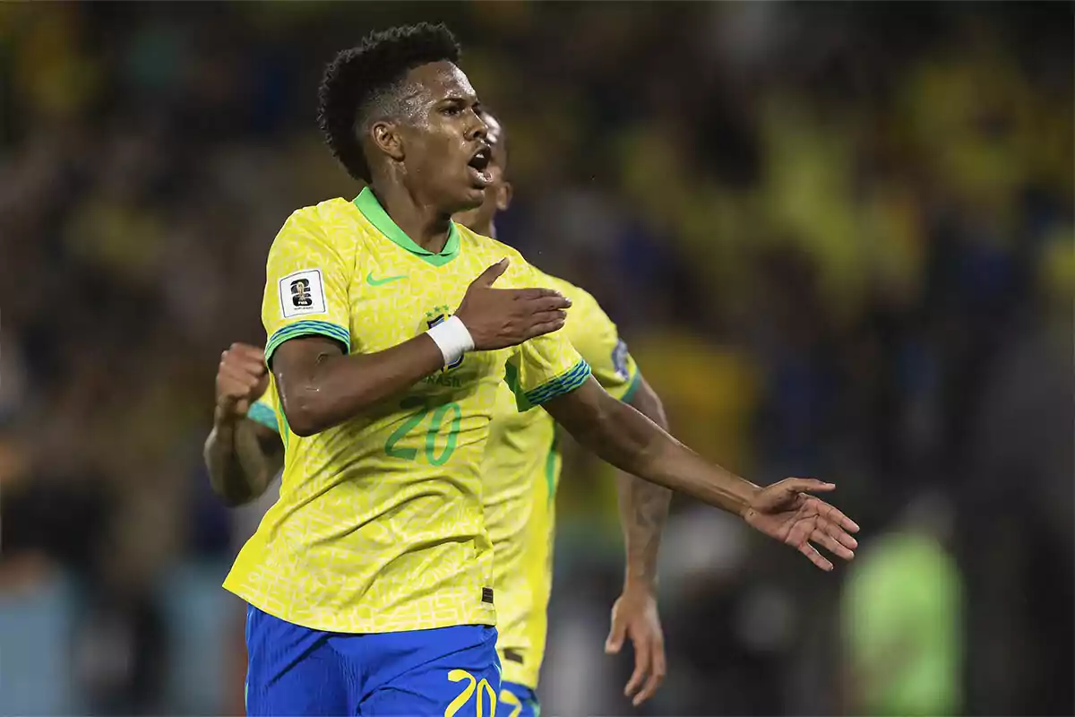 Soccer player in a yellow and blue uniform celebrating a goal in a stadium full of spectators Soccer player in a yellow and blue uniform celebrating a goal in a stadium full of spectators