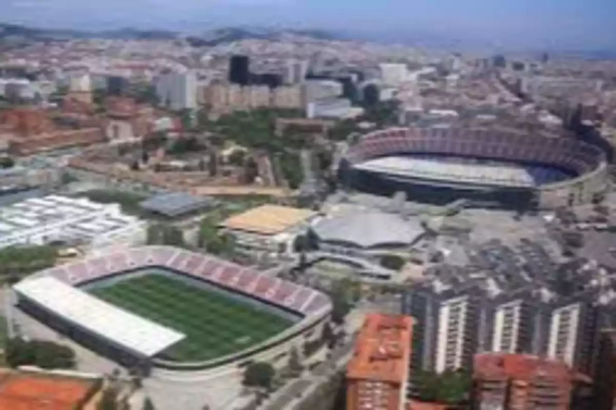 Aerial view of two soccer stadiums in a city surrounded by buildings and urban areas