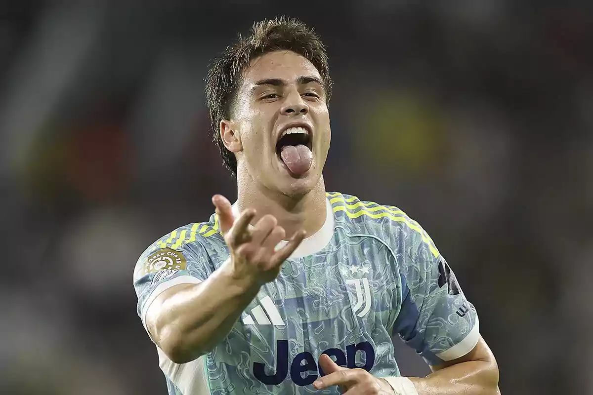 Soccer player celebrating a goal in a Juventus jersey, sticking out his tongue and extending one hand forward Soccer player celebrating a goal in a Juventus jersey, sticking out his tongue and extending one hand forward