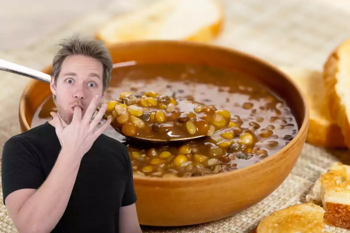 Surprised man licking his fingers in front of a plate of lentil soup with bread Surprised man licking his fingers in front of a plate of lentil soup with bread