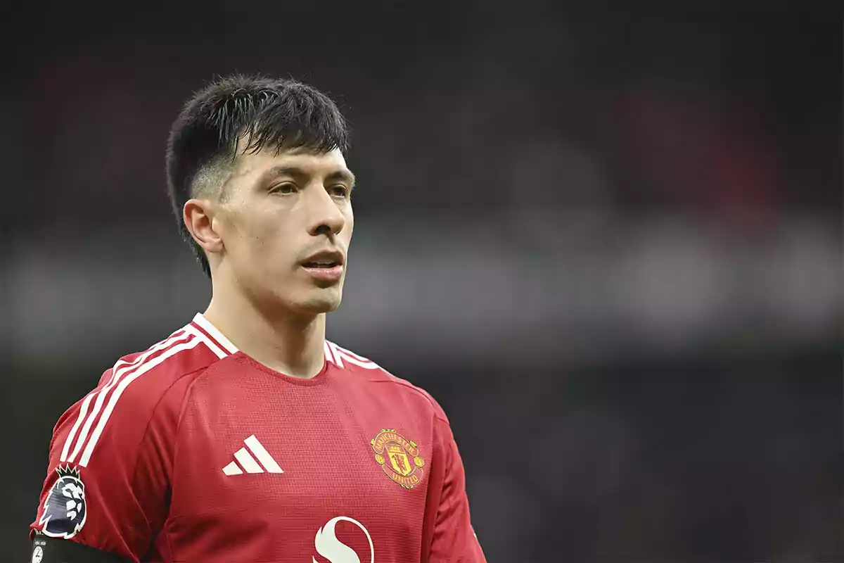 Soccer player wearing a red Manchester United jersey during a match Soccer player wearing a red Manchester United jersey during a match
