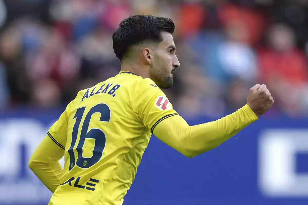 A player in a yellow uniform celebrates with a clenched fist. A player in a yellow uniform celebrates with a clenched fist.