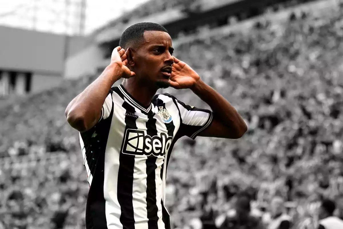 Alexander Isak puts his hands to his ears after scoring a goal for Newcastle