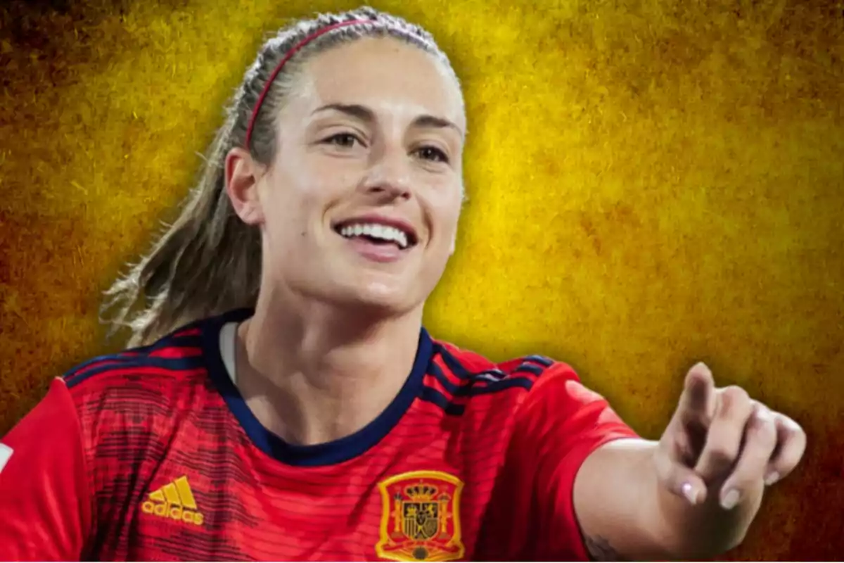 A smiling female soccer player wearing the Spanish national team jersey on a yellow background.