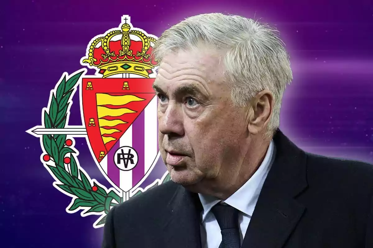 A grey-haired man in a dark suit in front of the Real Valladolid crest on a purple background.