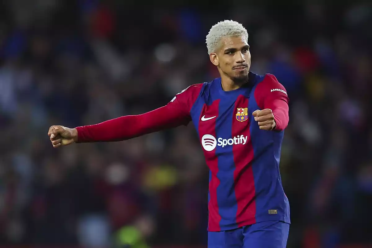 A player in the FC Barcelona uniform celebrates on the field.