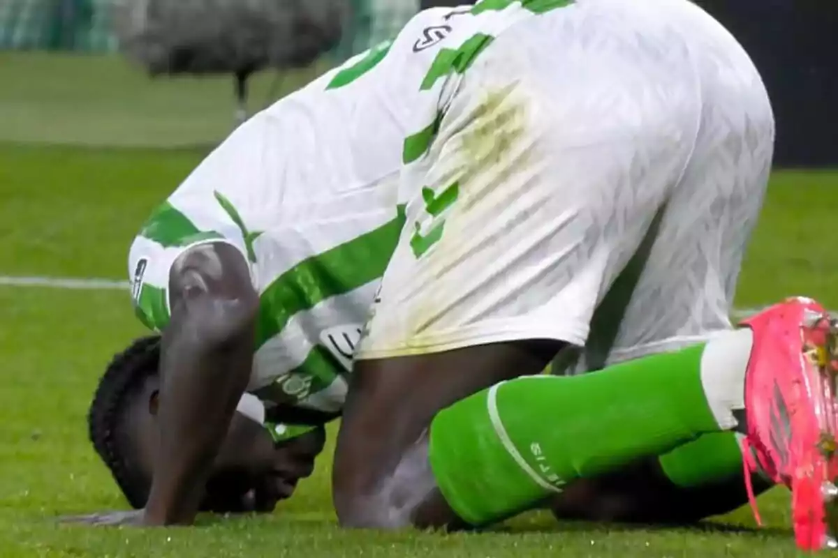 Assane Diao kneels on the field with his head bowed to the ground. Assane Diao kneels on the field with his head bowed to the ground.