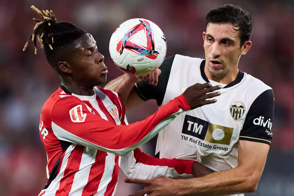 Two soccer players compete for the ball during a match.