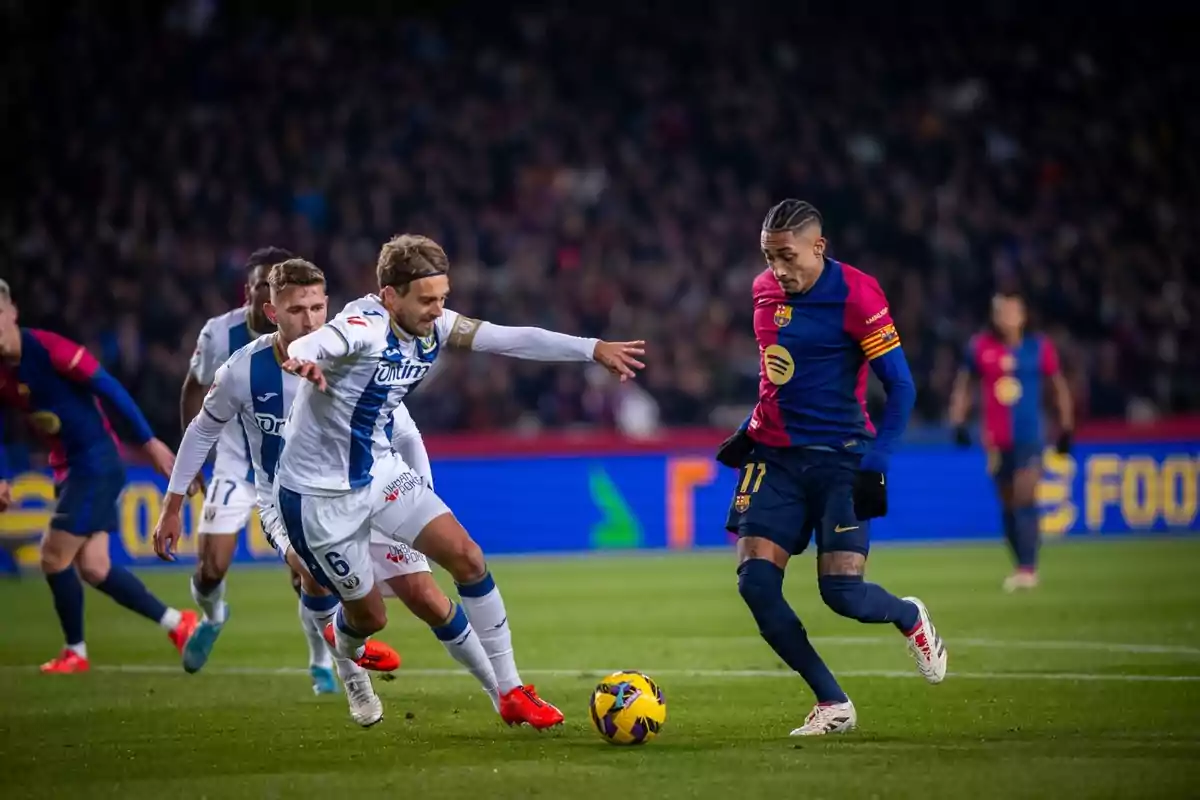 Soccer players compete for the ball in a match.