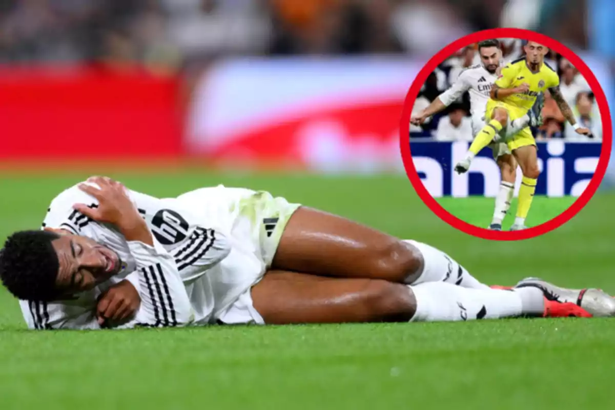 A soccer player in a white uniform lies on the ground with an expression of pain while a frame shows a play with another player in a yellow uniform.