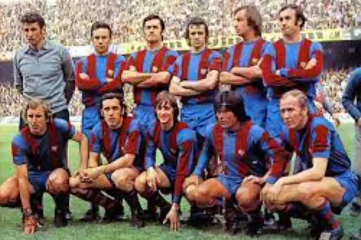 A soccer team posing on the field in blue and maroon uniforms. A soccer team posing on the field in blue and maroon uniforms.