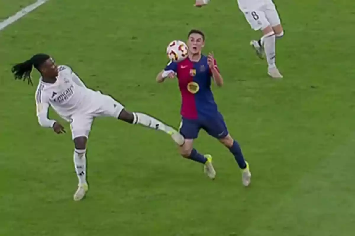 Two soccer players compete for the ball on the field during a match. Two soccer players compete for the ball on the field during a match.