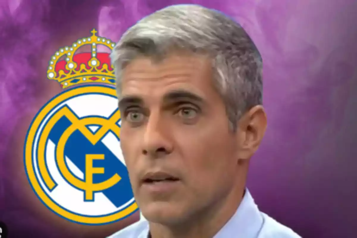 A gray-haired man with a serious expression is in front of a background with the Real Madrid crest.