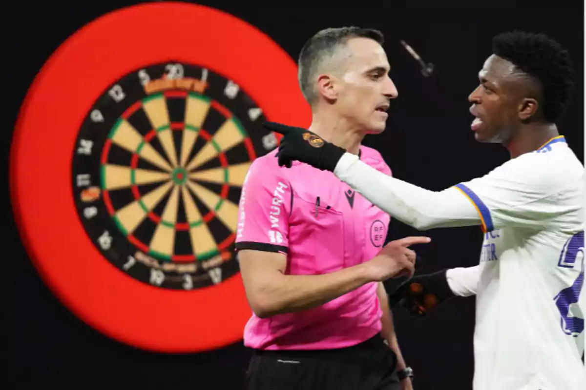 A player argues with a referee dressed in pink while a dartboard is in the background.