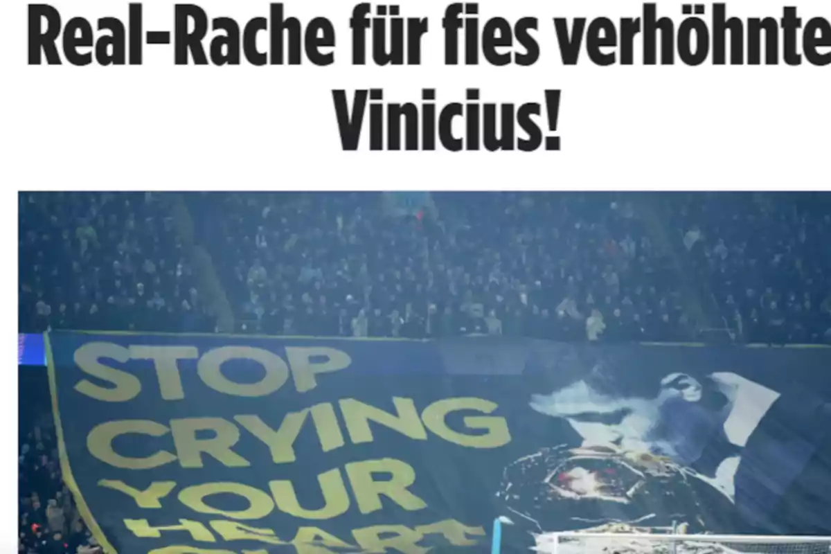 A sign in a soccer stadium displays the message "STOP CRYING YOUR HEART OUT" next to the image of a person kissing a trophy, with a crowd of spectators in the background.