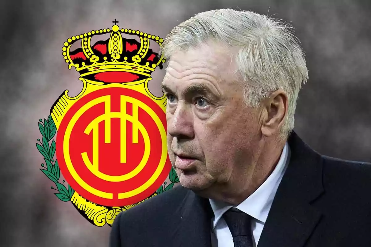 Carlo Ancelotti with a serious expression in front of RCD Mallorca's shield.