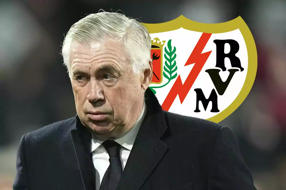 Carlo Ancelotti with a serious expression in front of the Rayo Vallecano crest.