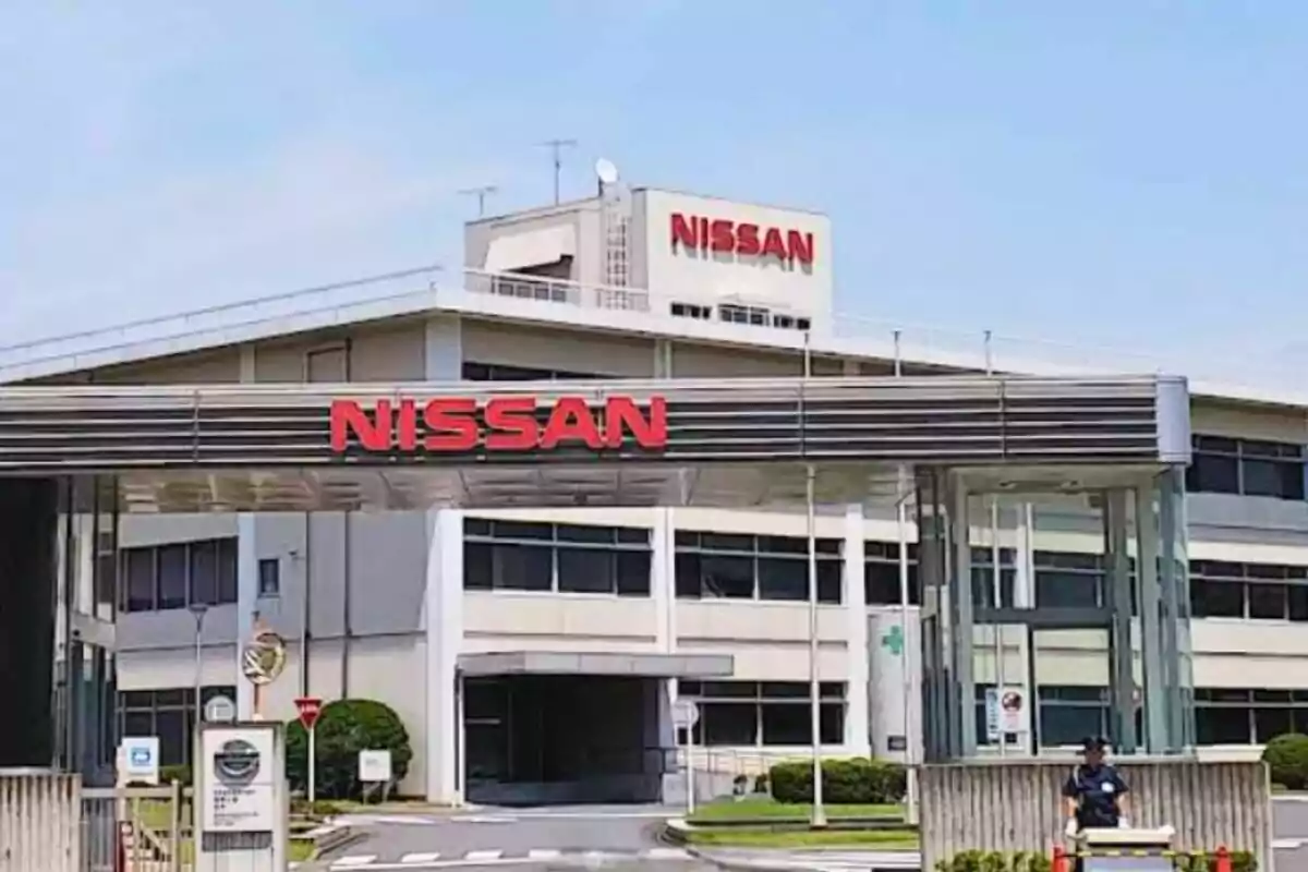 Facade of a Nissan industrial plant with the logo in red letters above the main entrance Facade of a Nissan industrial plant with the logo in red letters above the main entrance