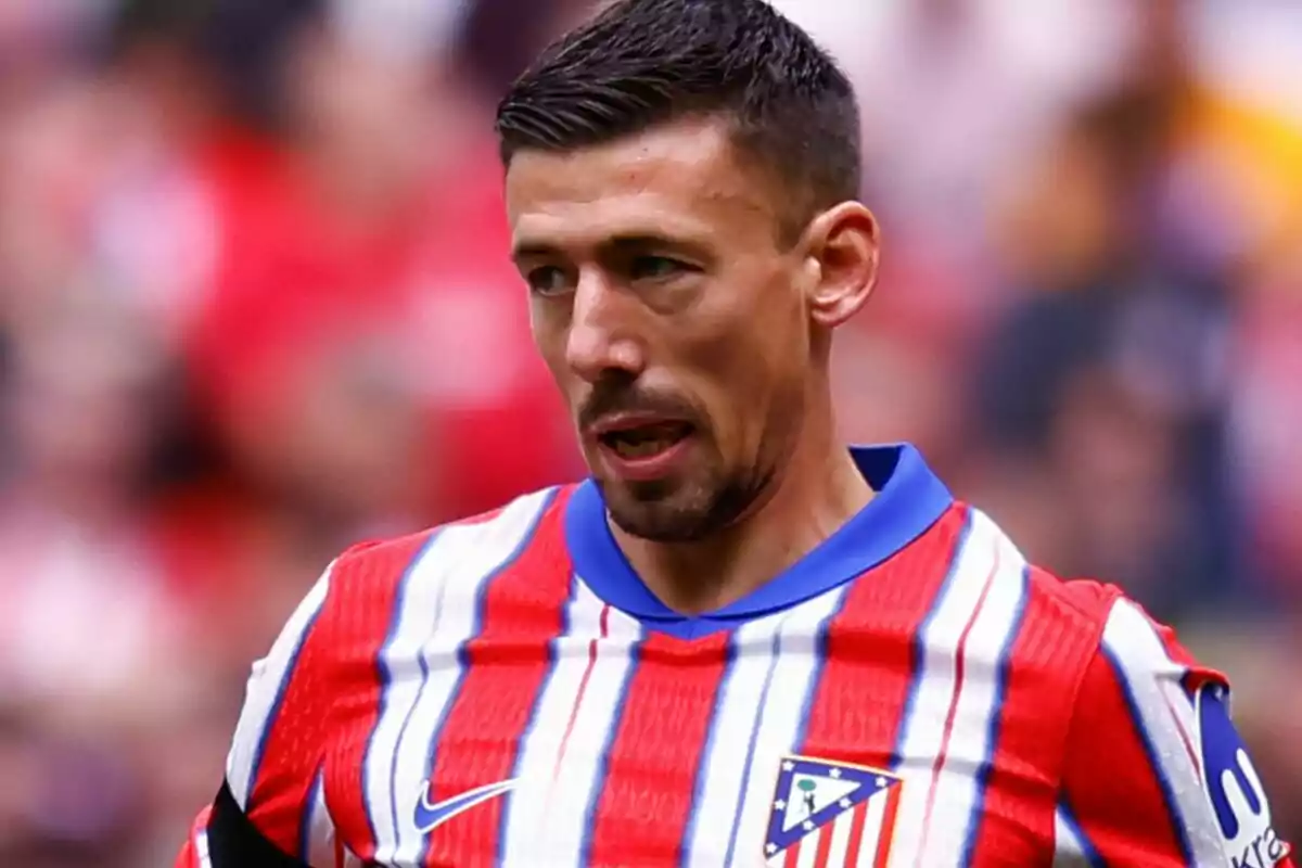 A soccer player wearing an Atlético de Madrid jersey on the field. A soccer player wearing an Atlético de Madrid jersey on the field.
