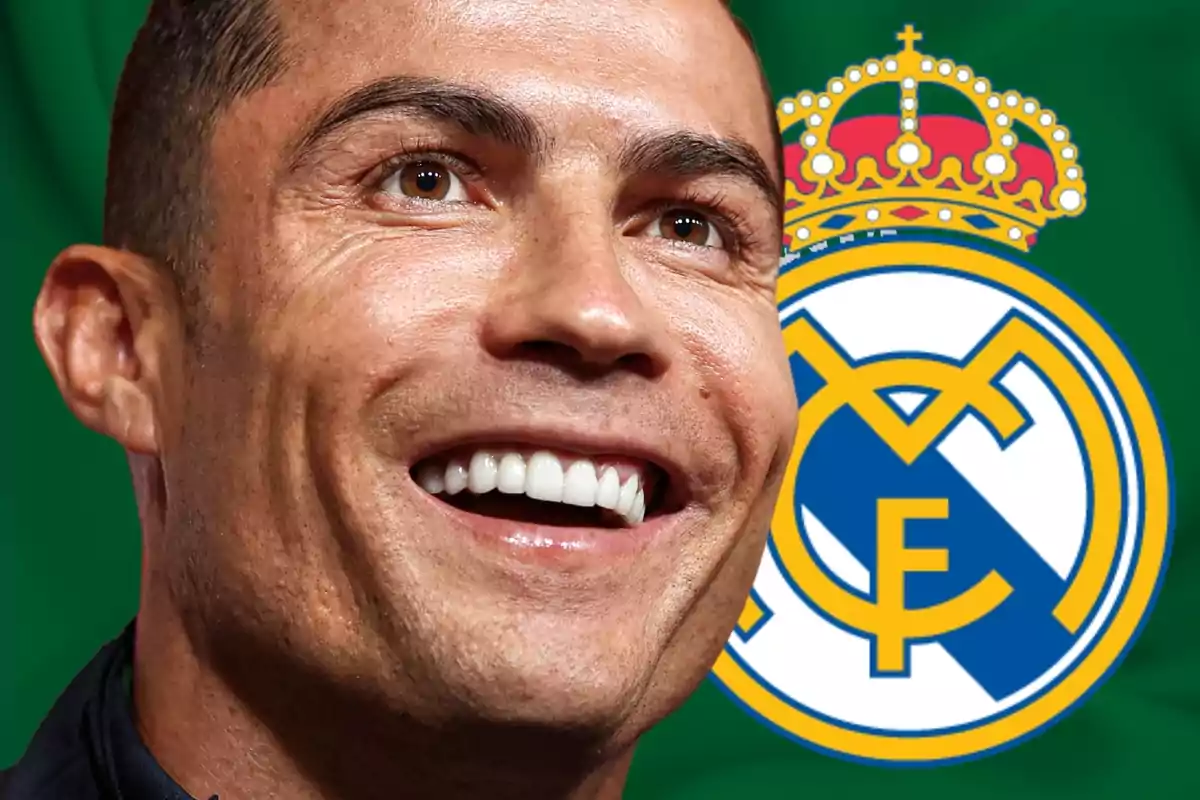 Cristiano Ronaldo with a big smile next to the Real Madrid shield