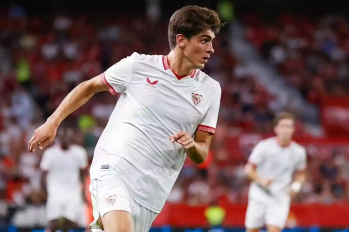 Sevilla FC football player running on the field during a match.