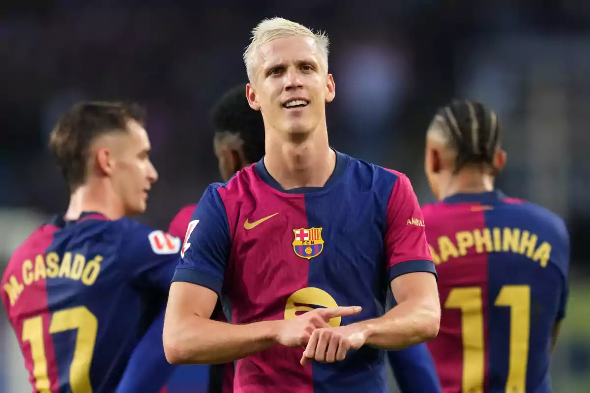 FC Barcelona soccer player celebrating on the field with teammates in the background. FC Barcelona soccer player celebrating on the field with teammates in the background.