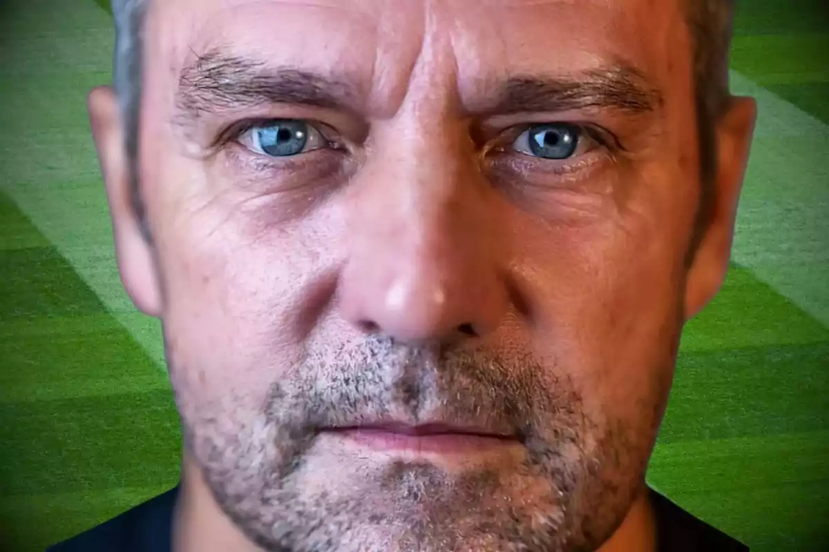 Close-up of a middle-aged man with a beard and blue eyes, against a background of green grass.