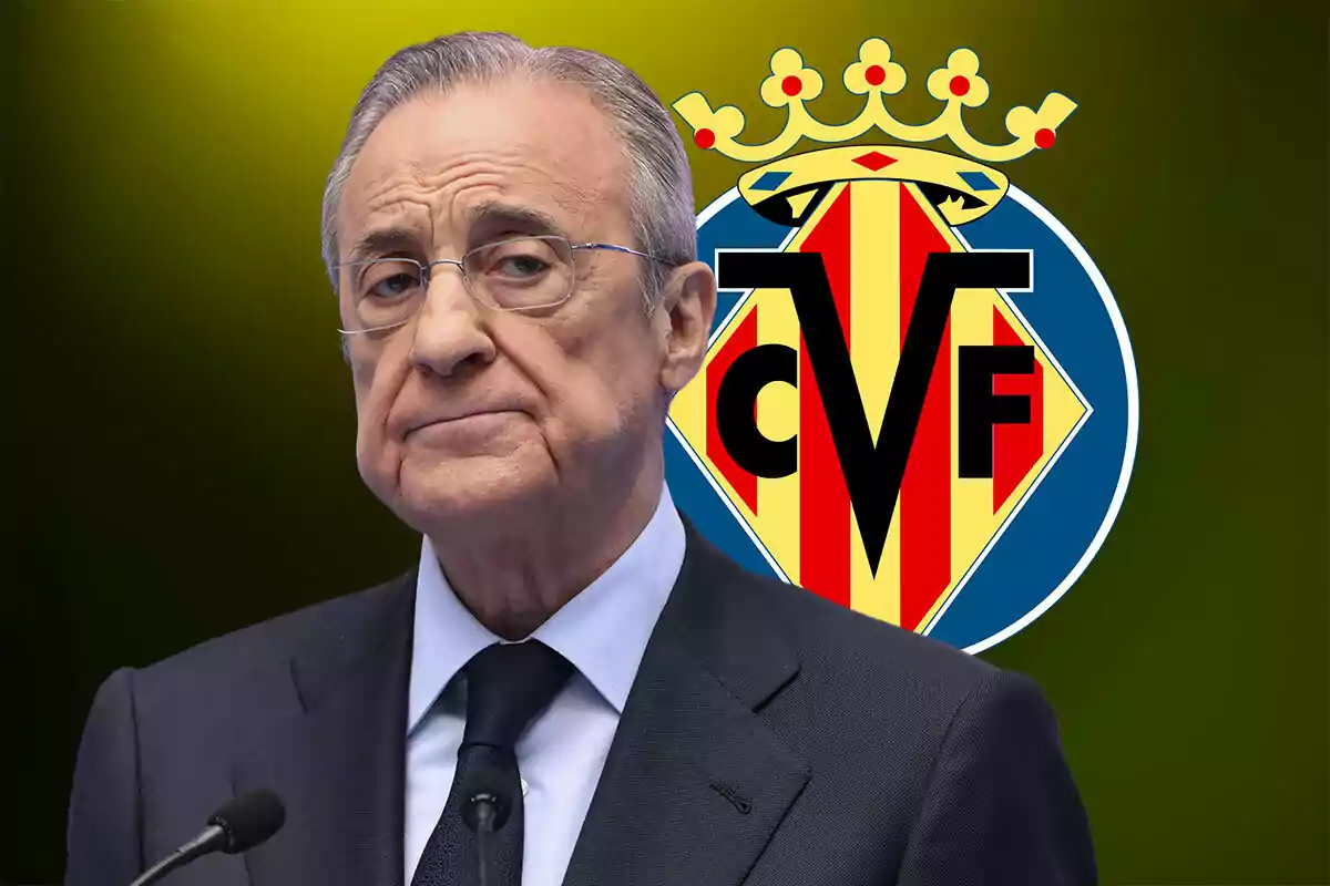 A man in a suit and glasses in front of a microphone with the Villarreal CF emblem in the background.