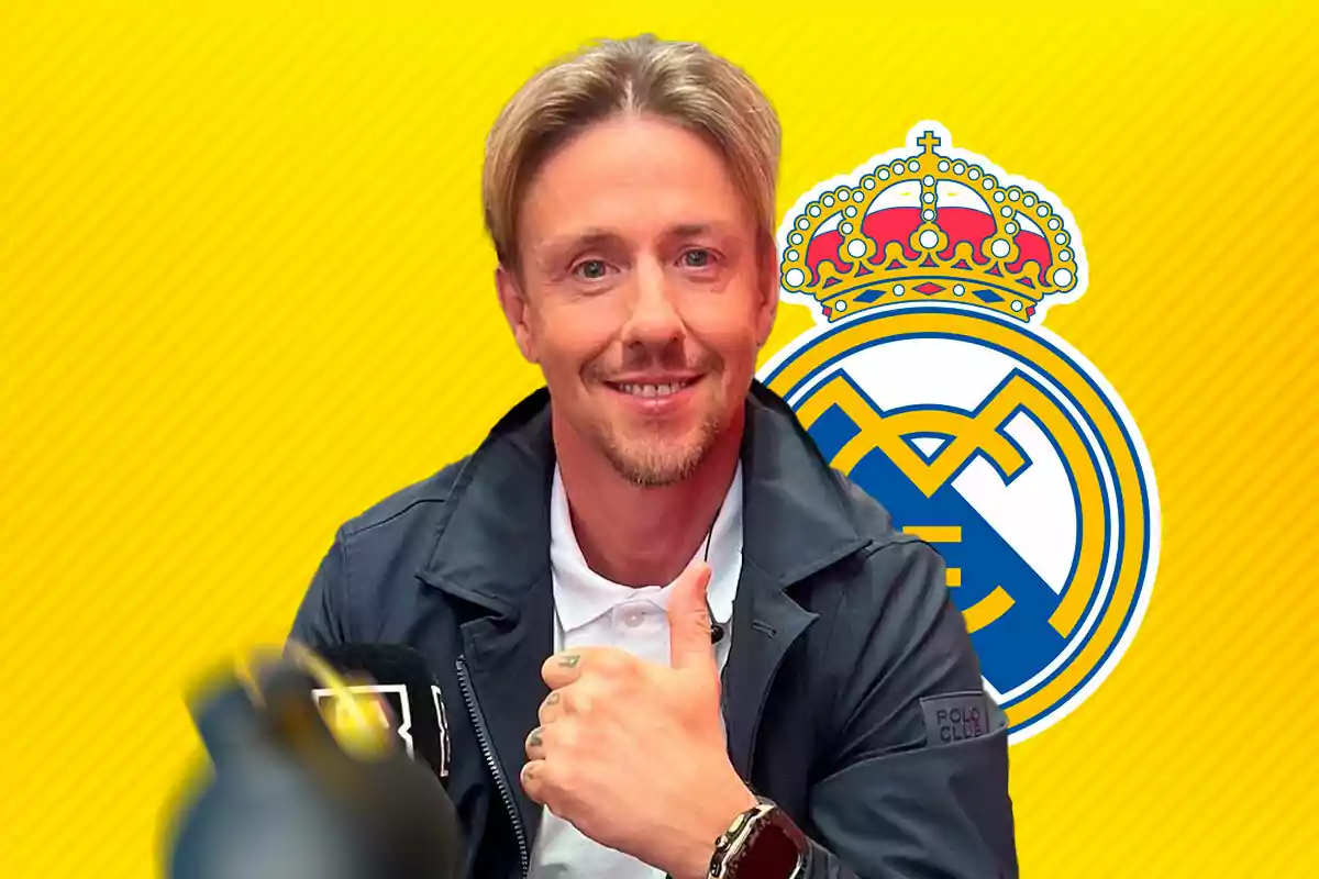 A smiling man with his thumb up in front of a yellow background with the Real Madrid crest.