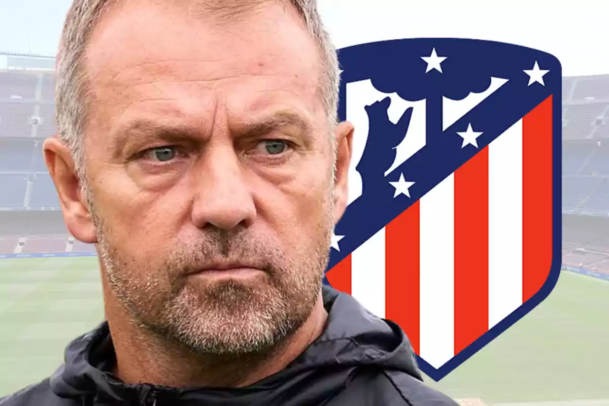 A man with a serious expression in front of the Atlético de Madrid crest in a stadium.