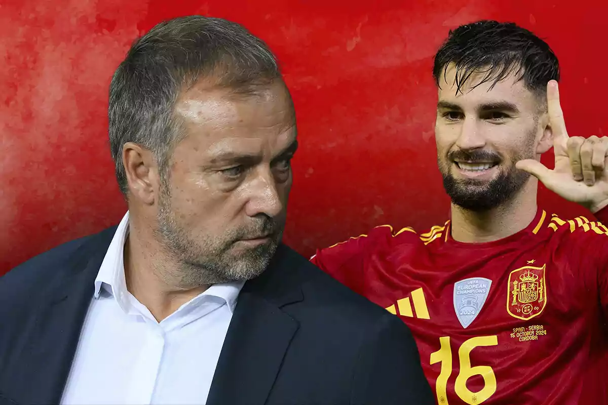 Hansi Flick con traje mira hacia Álex Baena que viste el uniforme de la selección española sobre un fondo rojo.